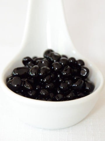 Balsamic vinegar pearls in a small dish.