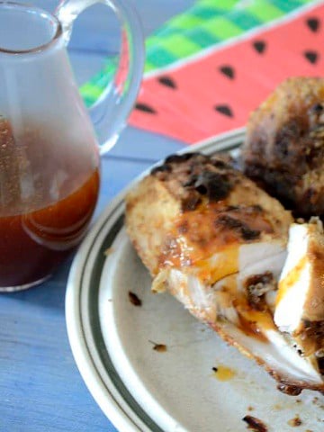 Air fried breaded pickle brined chicken on a plate drizzled with Hot Honey Sauce.