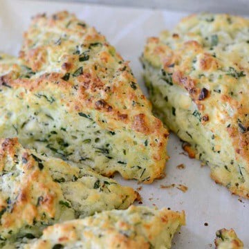 Golden brown spinach feta scones on a plate.